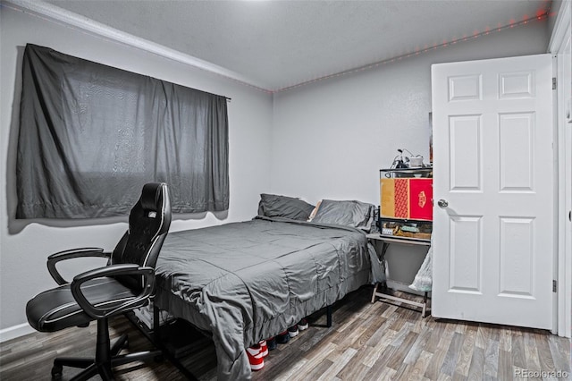 bedroom with hardwood / wood-style floors