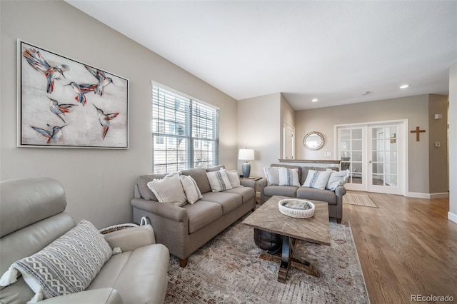 living room with recessed lighting, french doors, baseboards, and wood finished floors