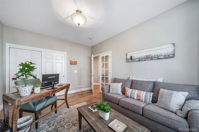 office space featuring french doors, visible vents, baseboards, and wood finished floors