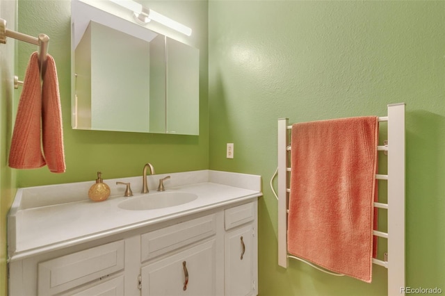 387 Upham St, Lakewood, CO 80226 - bathroom with vanity and a textured wall