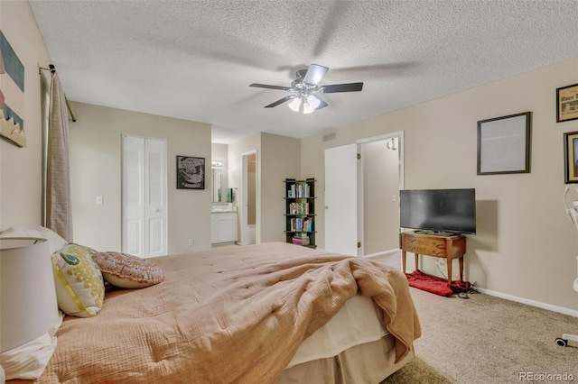 387 Upham St, Lakewood, CO 80226 - carpeted bedroom with connected bathroom, baseboards, a ceiling fan, and a textured ceiling