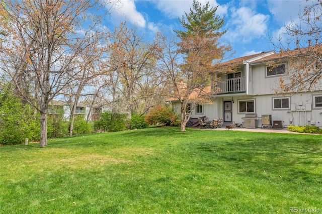 387 Upham St, Lakewood, CO 80226 - view of green lawn with a balcony and a patio area