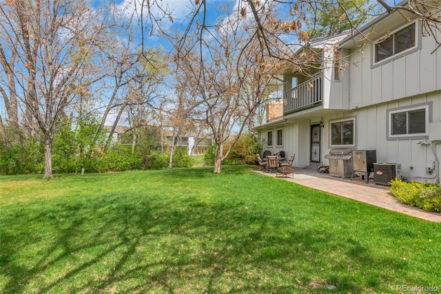 387 Upham St, Lakewood, CO 80226 - view of grassy yard featuring a balcony, a patio area, and cooling unit