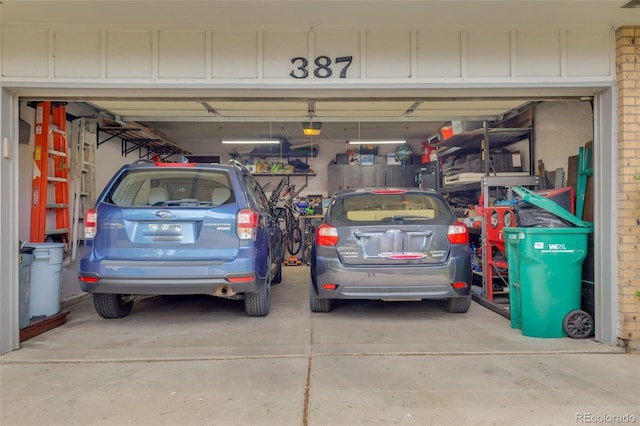 387 Upham St, Lakewood, CO 80226 - garage featuring a garage door opener and driveway