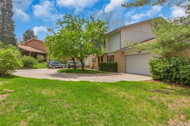 387 Upham St, Lakewood, CO 80226 - multi unit property with driveway, board and batten siding, a front lawn, brick siding, and an attached garage