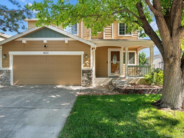 4111 W Kenyon Ave, Denver, CO 80236 - view of front of property featuring a porch, driveway, stone siding, and a garage