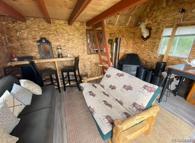 interior space with hardwood / wood-style floors and lofted ceiling with beams