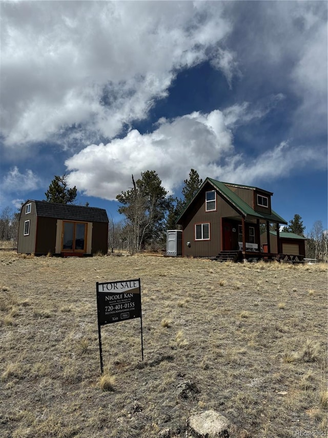 125 Chamber Ln, Jefferson, CO 80456 - view of side of property featuring covered porch, an outdoor structure, and a storage unit