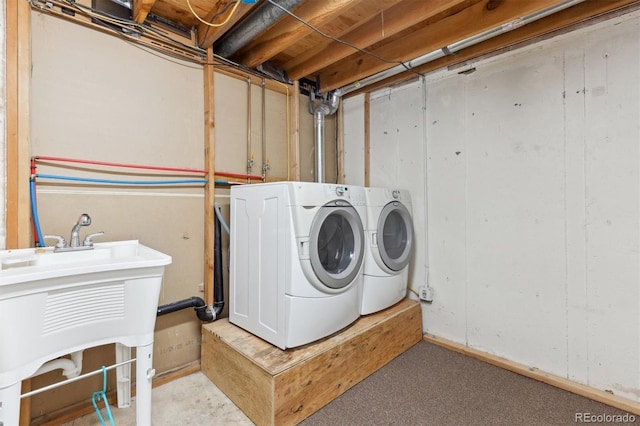 laundry room with separate washer and dryer and sink