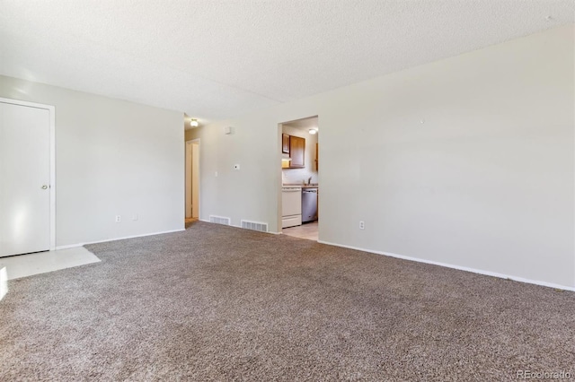 carpeted spare room featuring a textured ceiling