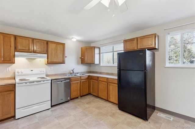 kitchen featuring black refrigerator, electric range, plenty of natural light, and dishwasher