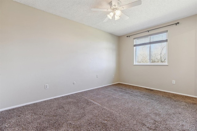 carpeted spare room with ceiling fan and a textured ceiling