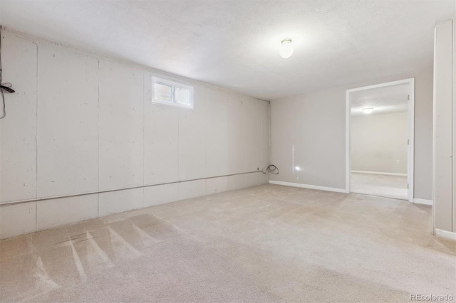 basement with light carpet and a textured ceiling