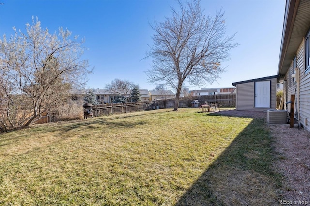 view of yard with central AC unit and a storage unit