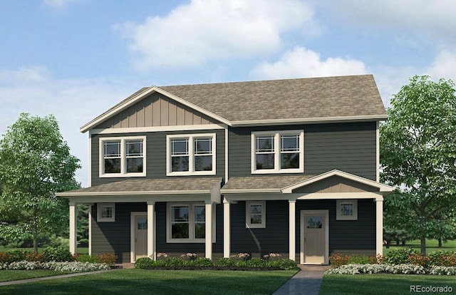 view of front of house with roof with shingles, board and batten siding, and a front lawn