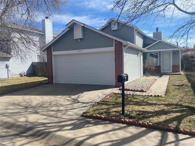 view of property exterior featuring brick siding, concrete driveway, an attached garage, and a chimney
