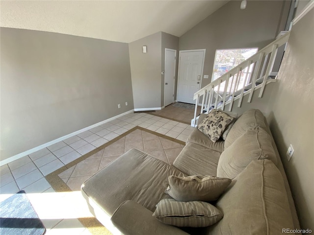 tiled living area featuring baseboards, stairs, and high vaulted ceiling