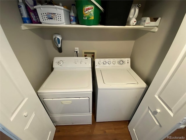 laundry room featuring washer and clothes dryer, wood finished floors, and laundry area