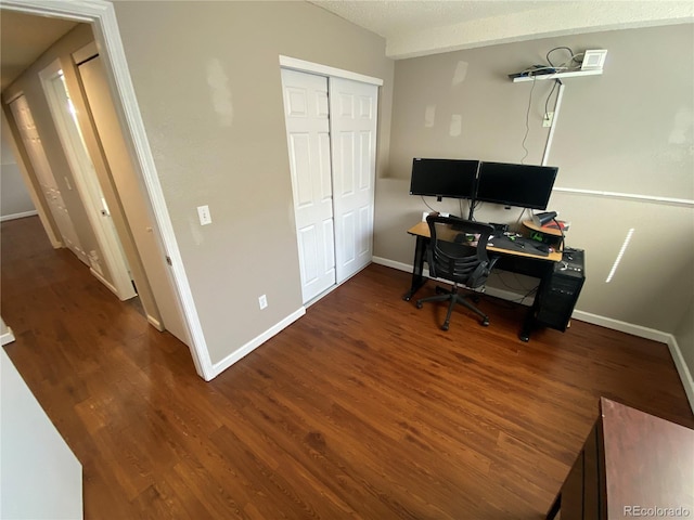 office with baseboards, wood finished floors, and a textured ceiling