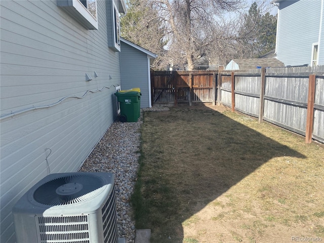 view of yard with cooling unit and fence