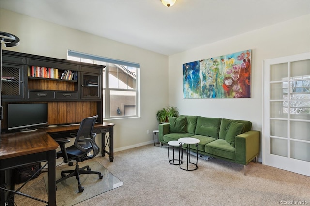 carpeted home office with baseboards
