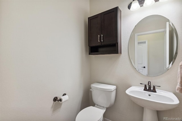 bathroom with toilet and a sink