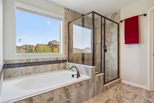 bathroom with plenty of natural light, a bath, and a shower stall