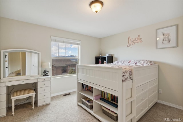bedroom with light carpet and baseboards