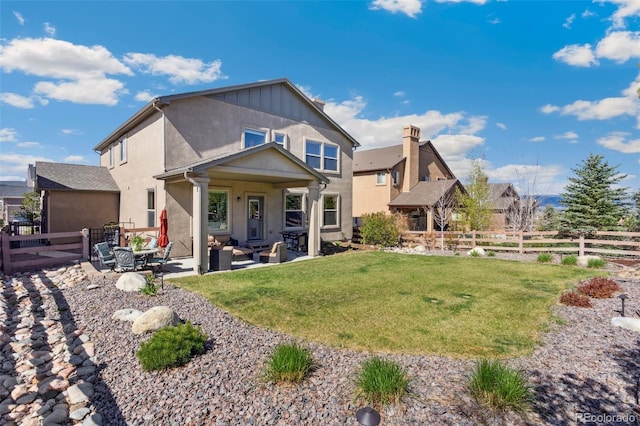 back of property with stucco siding, a patio area, and an outdoor living space