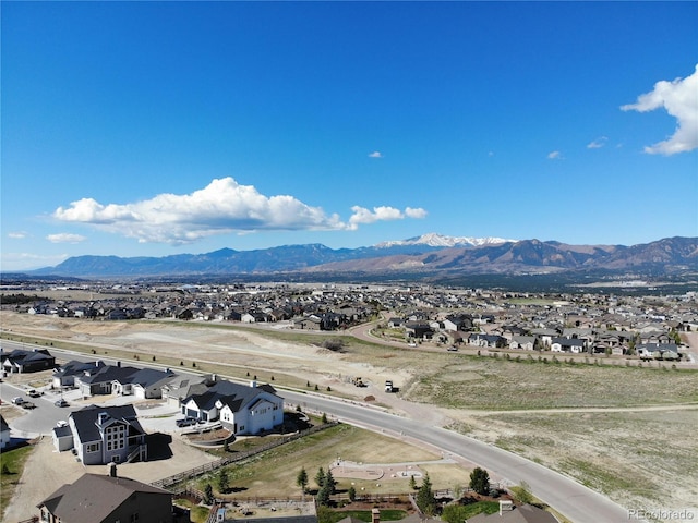 view of mountain backdrop featuring nearby suburban area