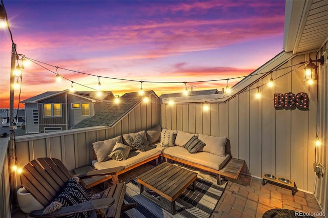 patio terrace at dusk featuring an outdoor living space