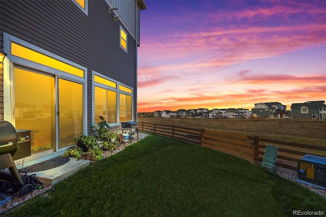 view of yard at dusk