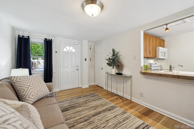 living room with light wood-style floors and baseboards