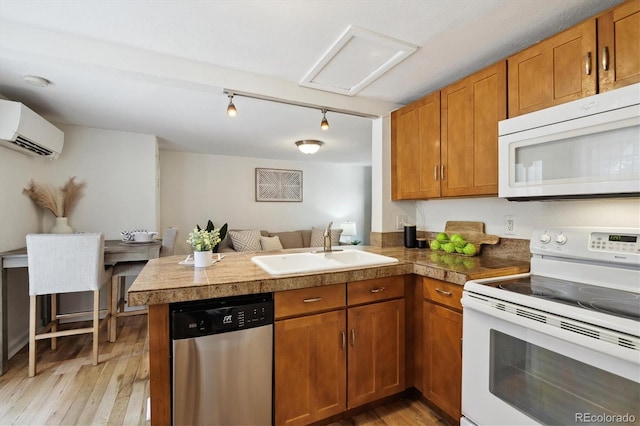 1532 N High St Unit 1, Denver, CO 80218 - kitchen with white appliances, tile counters, a peninsula, a wall unit AC, and light wood finished floors