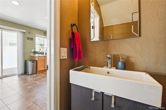 5552 Odessa St, Denver, CO 80249 - bathroom with a textured wall, a sink, and tile patterned flooring
