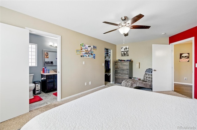 5552 Odessa St, Denver, CO 80249 - carpeted bedroom with a walk in closet, ensuite bathroom, a closet, a ceiling fan, and baseboards