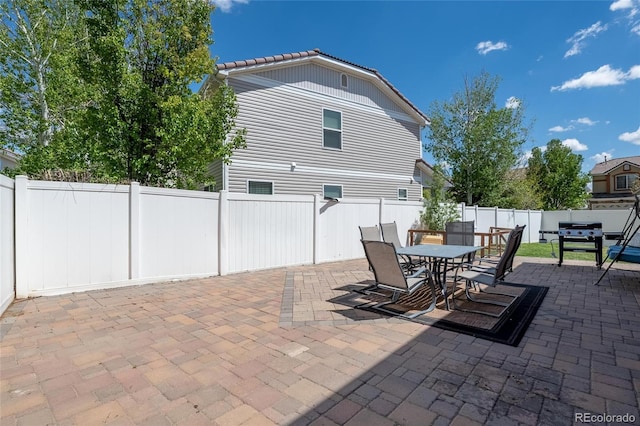 5552 Odessa St, Denver, CO 80249 - view of patio featuring outdoor dining space and a fenced backyard