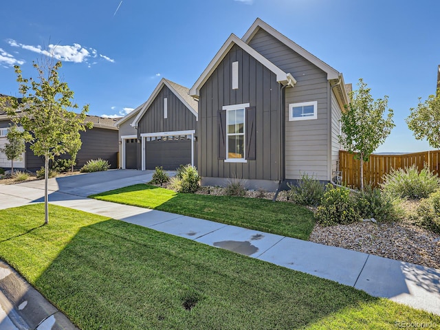 view of front of house with board and batten siding, fence, concrete driveway, and a garage