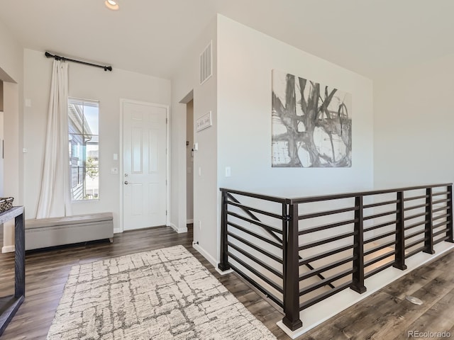foyer entrance with baseboards, recessed lighting, wood finished floors, and visible vents