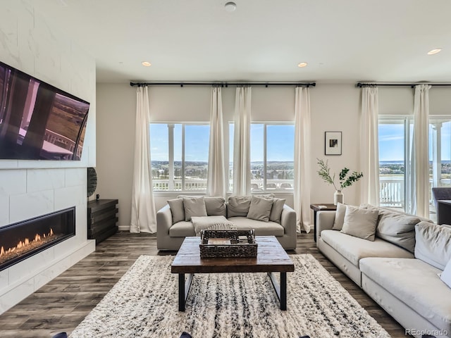 living room featuring recessed lighting, a fireplace, and dark wood-style floors