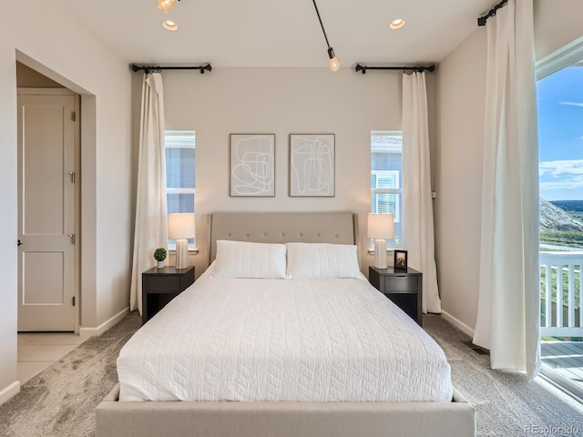 carpeted bedroom with baseboards, access to outside, tile patterned floors, and recessed lighting