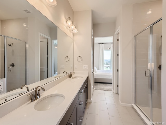 bathroom featuring visible vents, a sink, tile patterned flooring, and a shower stall