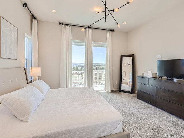bedroom featuring an inviting chandelier, recessed lighting, light colored carpet, and access to exterior