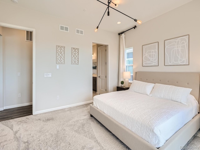 bedroom featuring baseboards, visible vents, and carpet