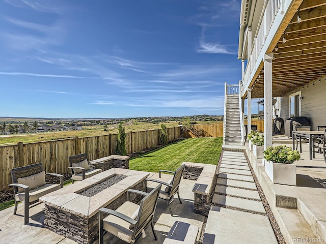 view of patio / terrace with stairs, a fenced backyard, and an outdoor fire pit