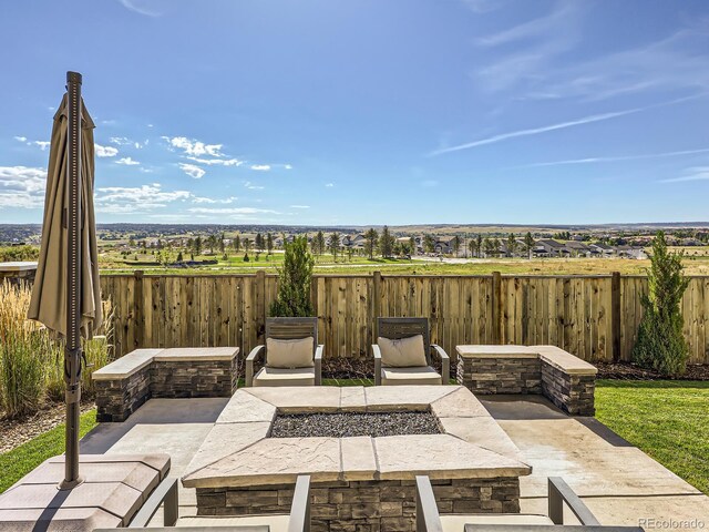 14440 Hop Clover Trl, Parker, CO 80134 - view of patio / terrace with an outdoor fire pit and fence