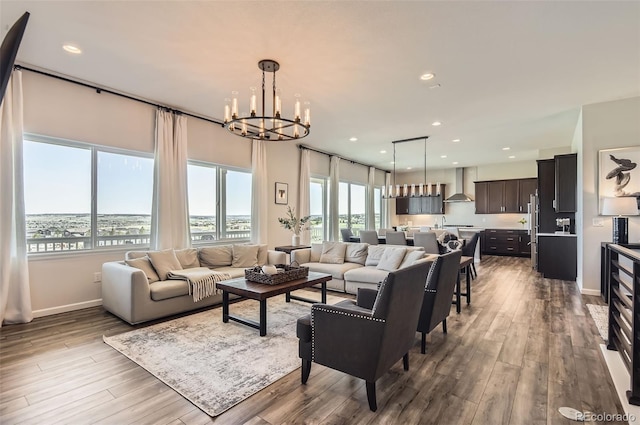 14440 Hop Clover Trl, Parker, CO 80134 - living room featuring a chandelier, wood finished floors, baseboards, and recessed lighting