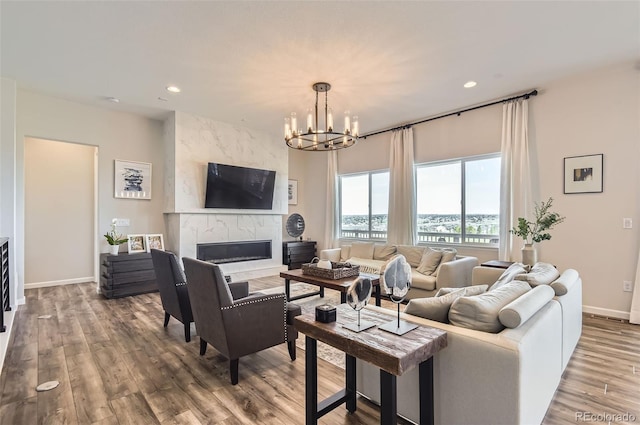14440 Hop Clover Trl, Parker, CO 80134 - living room with a chandelier, recessed lighting, a high end fireplace, wood finished floors, and baseboards