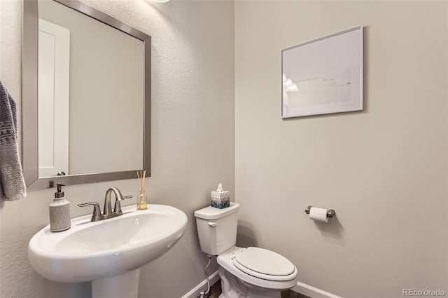 14440 Hop Clover Trl, Parker, CO 80134 - half bathroom with baseboards, a sink, and toilet