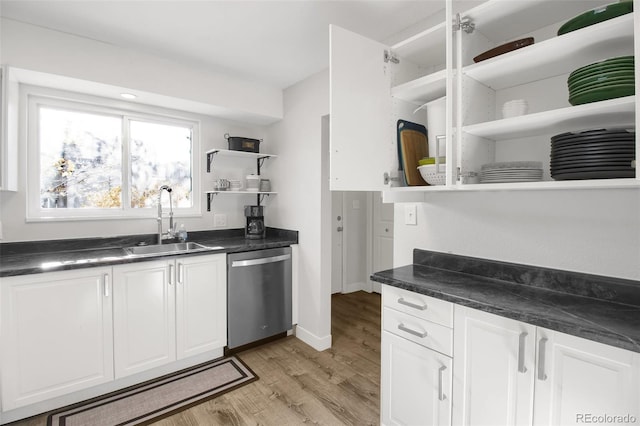 kitchen with dark countertops, stainless steel dishwasher, and open shelves